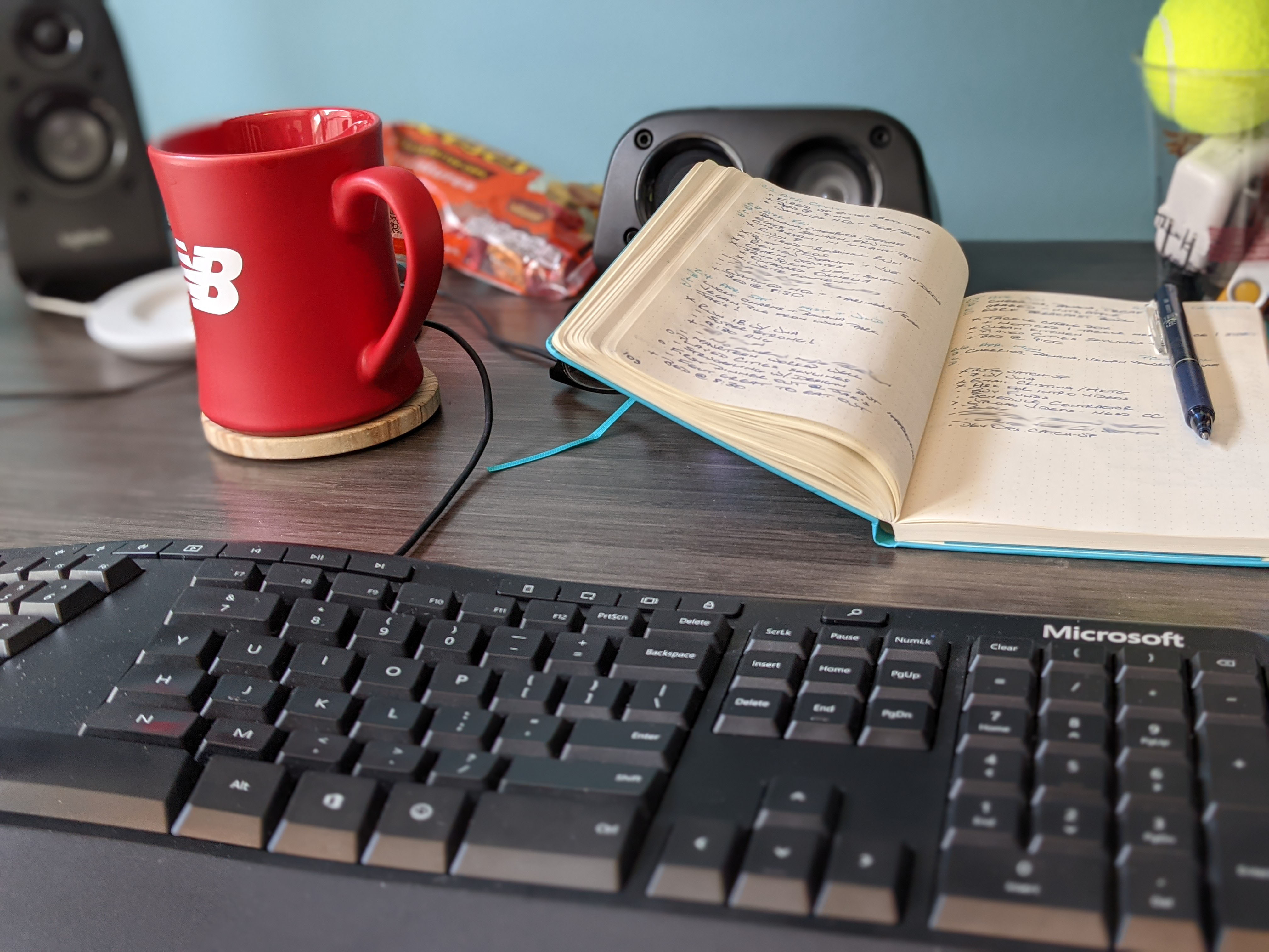 Keyboard with my bullet journal sitting in the background